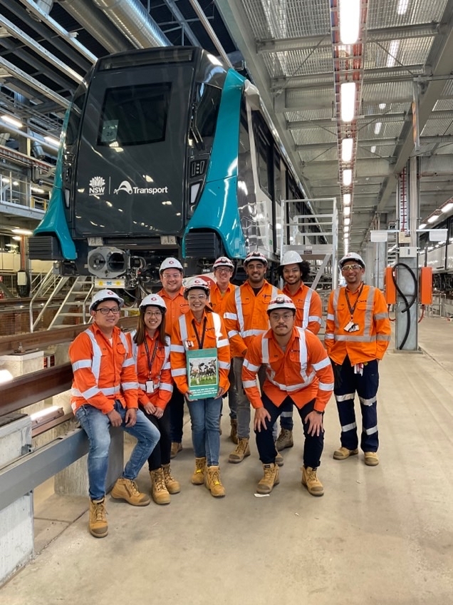 Candy (holding a plate) worked on the extension of the first fully automated metro in Australia and her team gave her a warm farewell before she left the company.