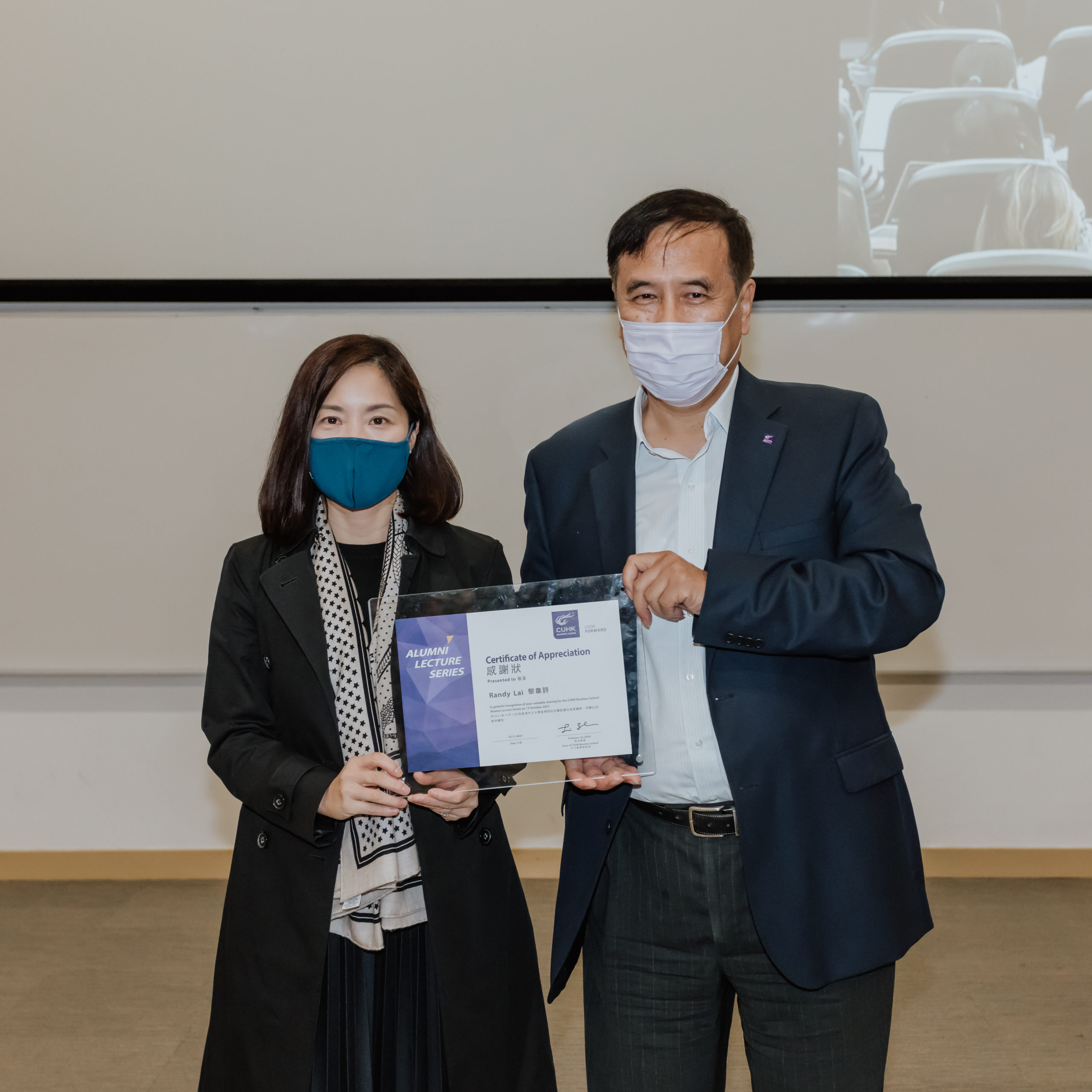 Professor Lin Zhou (right), Dean of the CUHK Business School, presenting a Certificate of Appreciation to Randy to recognise her unwavering support to CUHK Business School